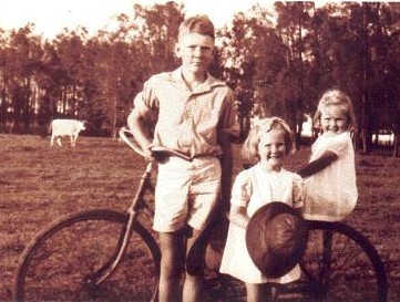 Trio of children with a bike